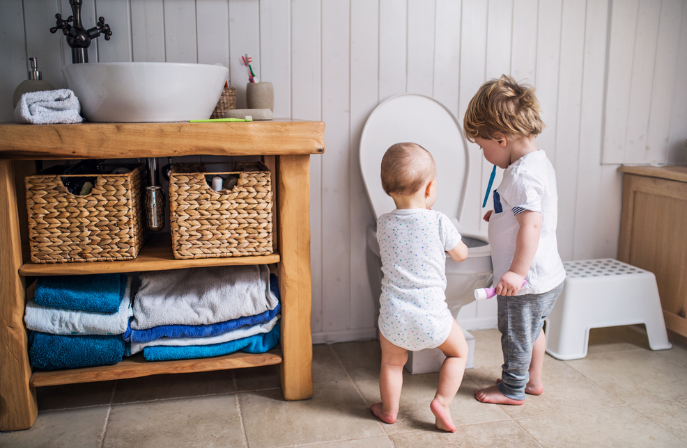 Children near Bathroom Toilet