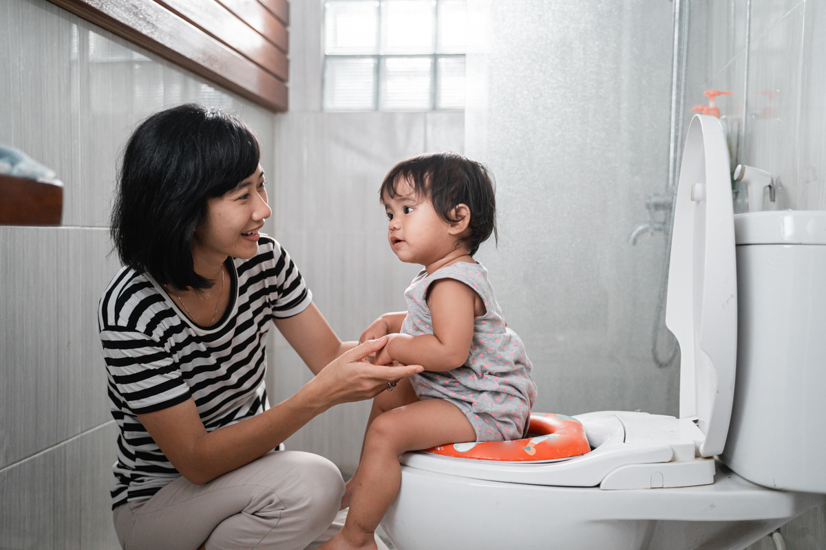 Woman and Baby Poop with Toilet Background