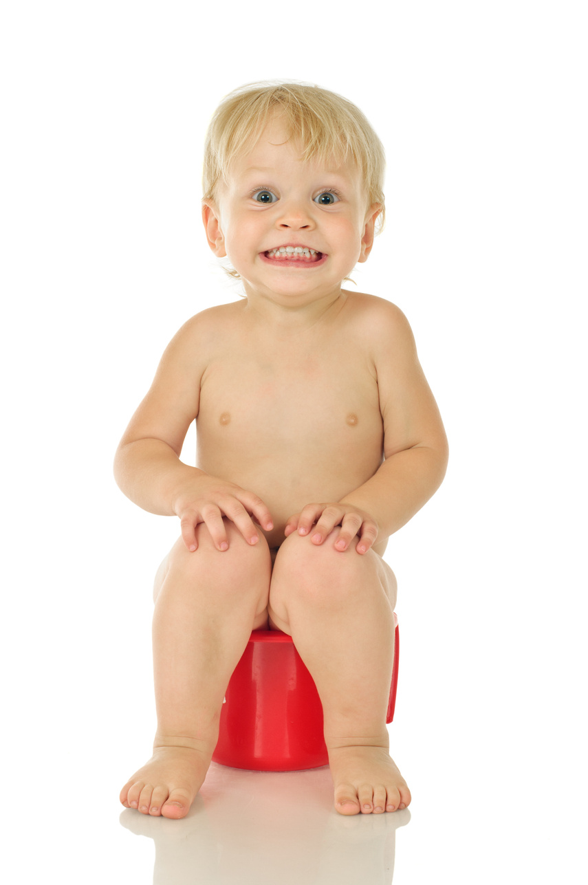 Happy child using the red toilet